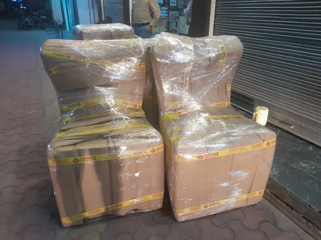 Household furniture stretch-wrapped and strapped by Agarwal Packers and Movers, ready to load in Dehradun